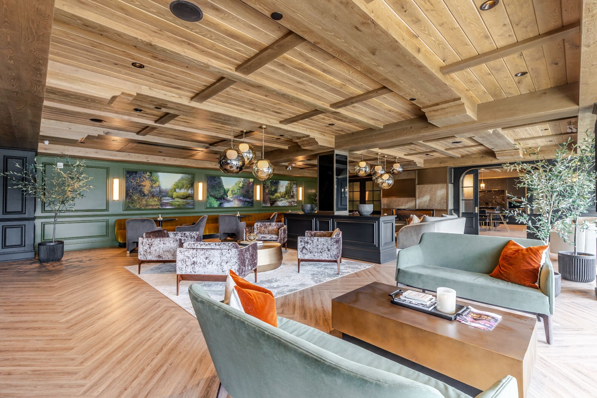 Luxury common amenities area with custom millwork by Homestead Woodworks, featuring elegant seating and stylish wood paneling